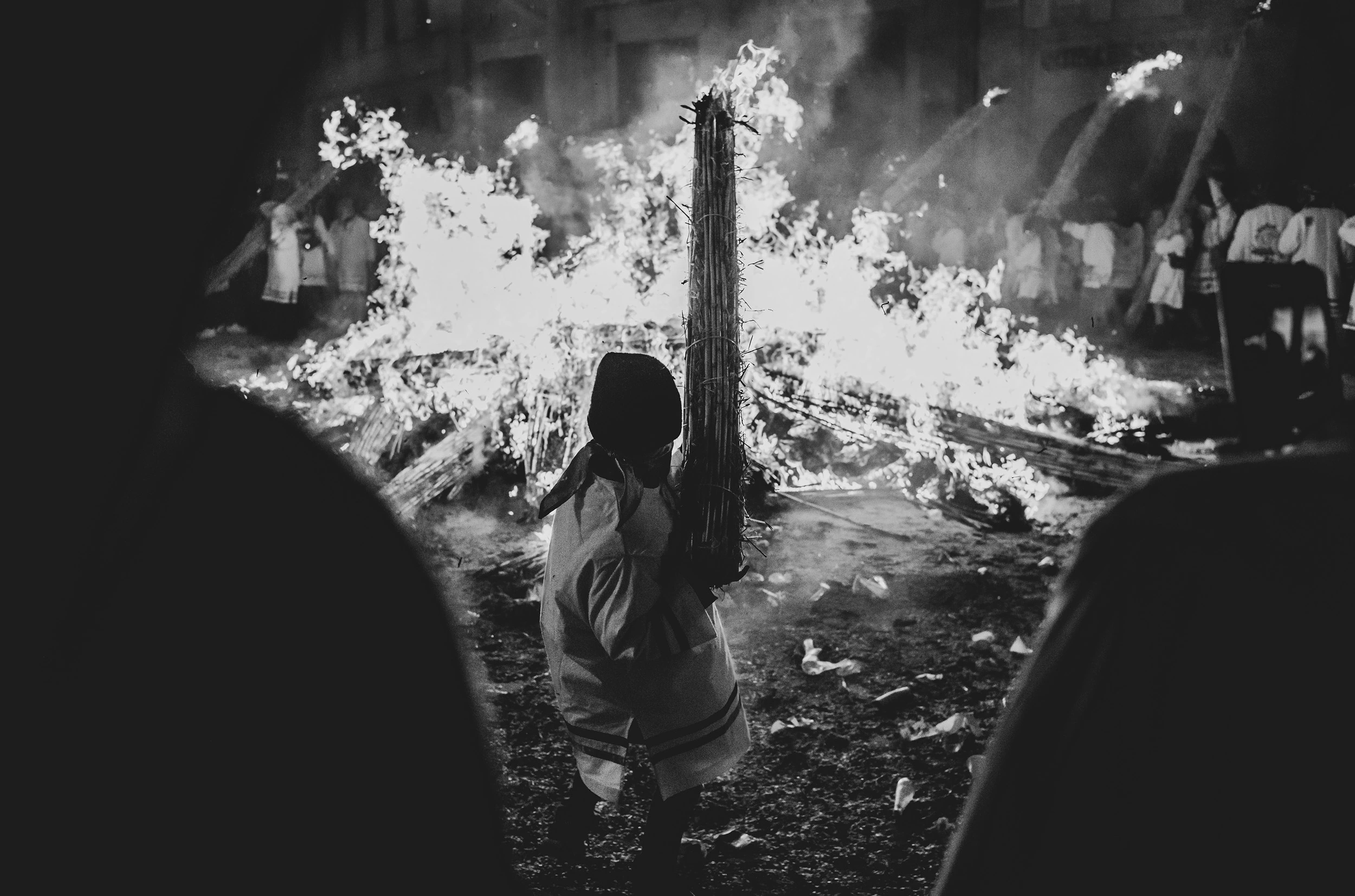 A figure backlit against the burning canes.
