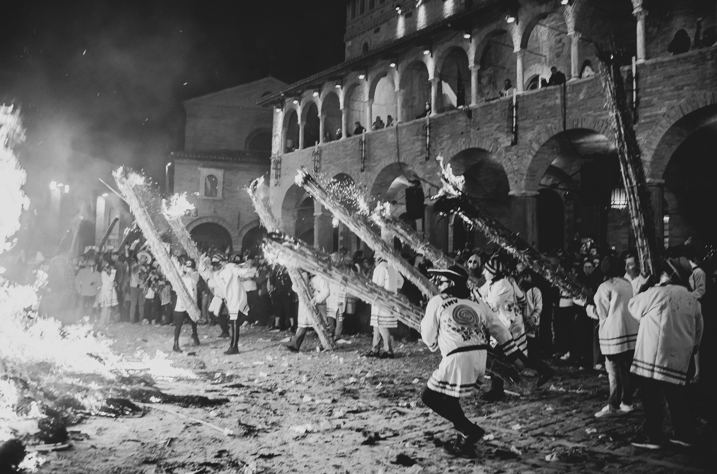 In the arcaded square, the burning vlurd dragged among the people in white.