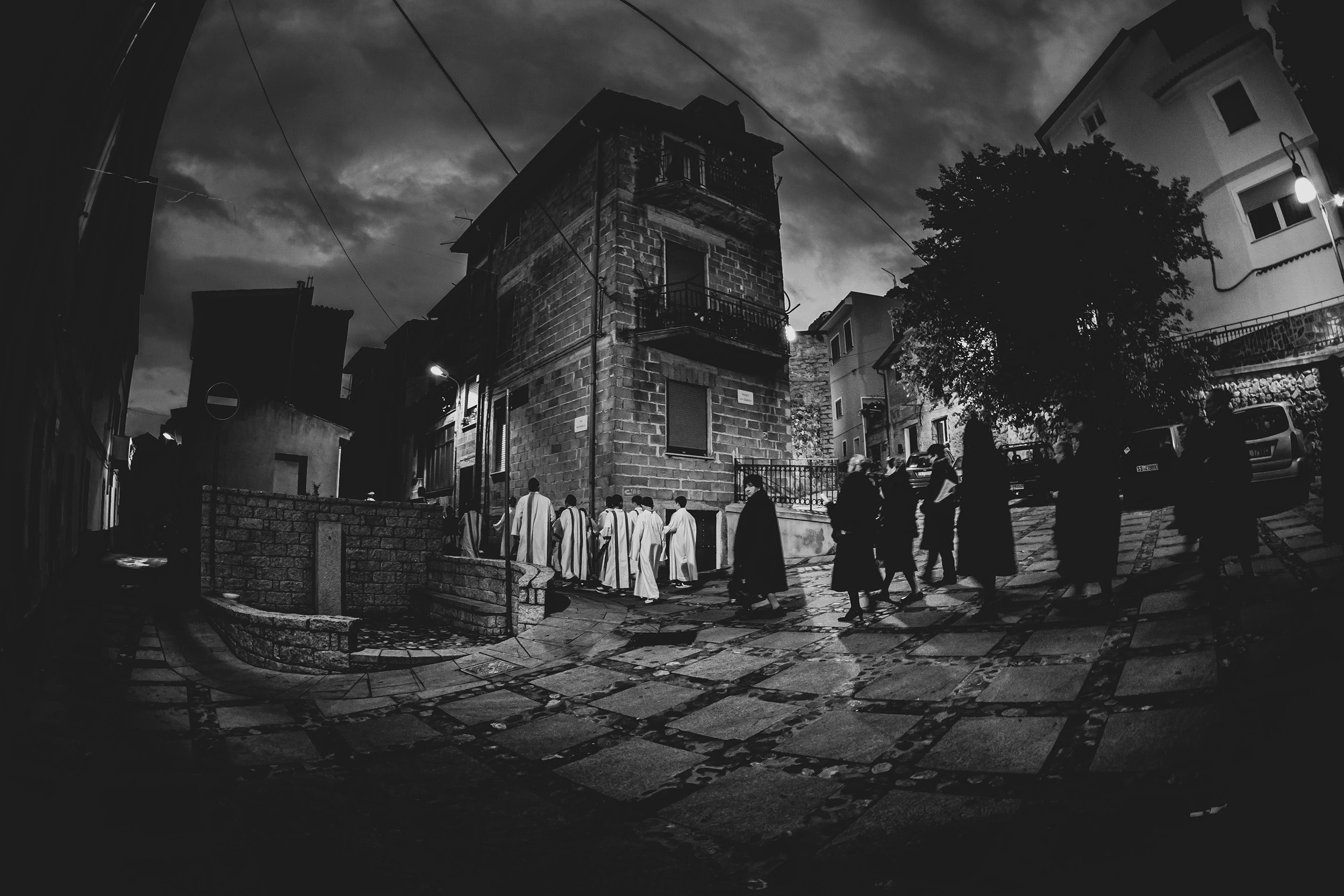 At dusk, the costumed participants gathered beside the stone tower-house.