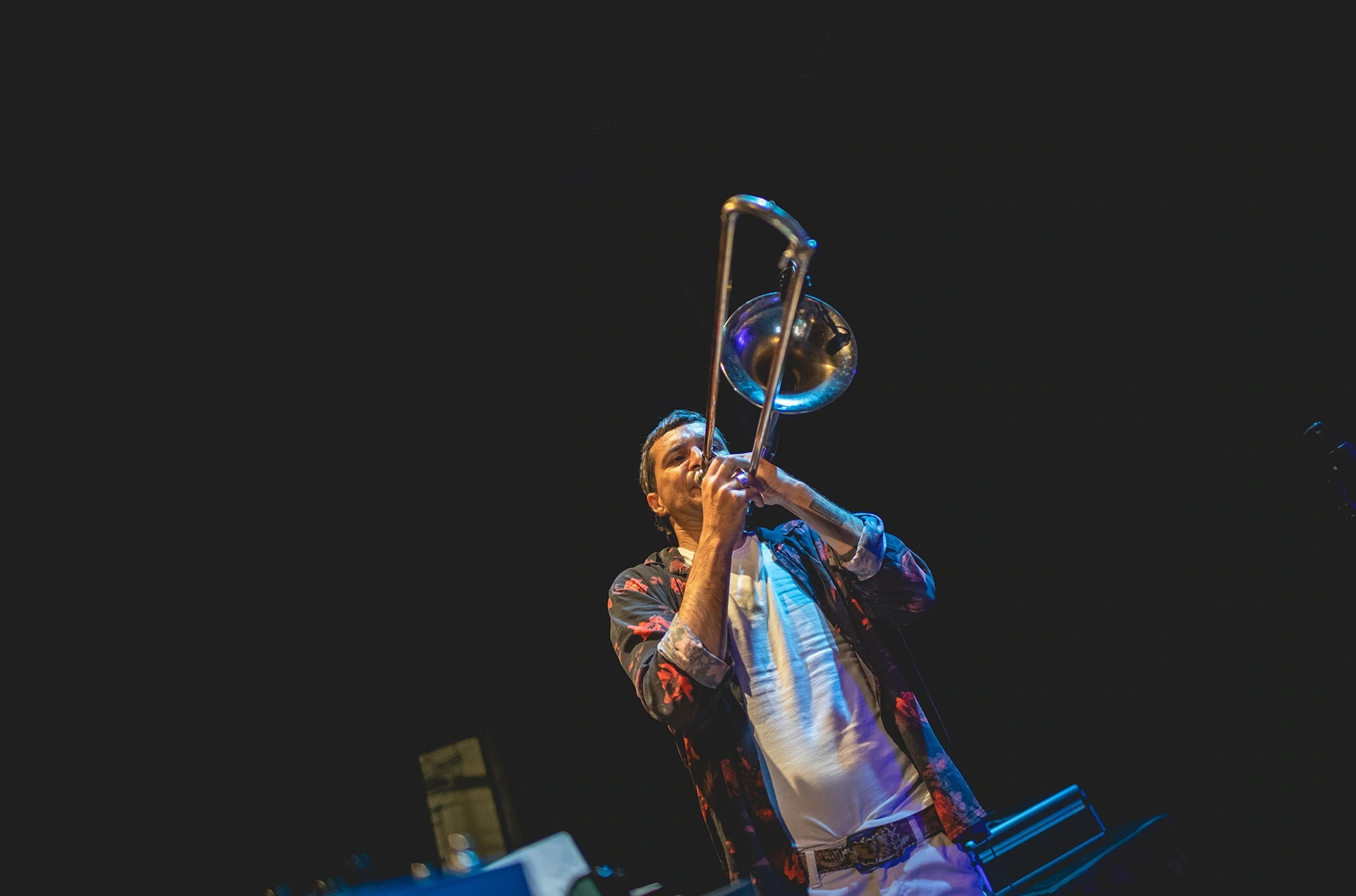 A trombone raised high, mid-solo.
