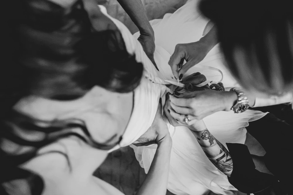 Hair swinging as hands close the dress.