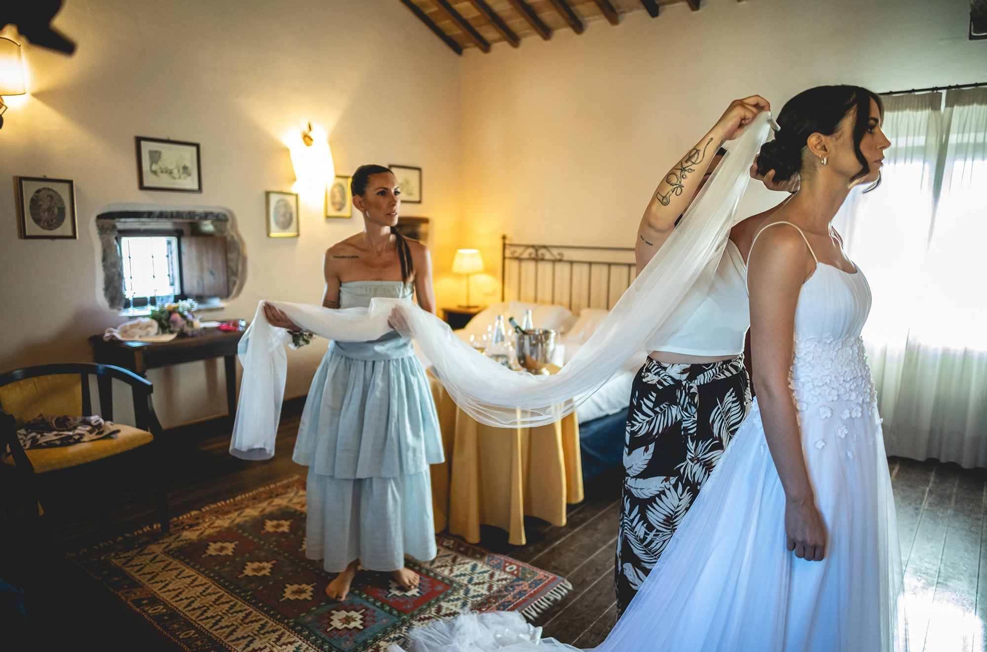 In the bedroom, the veil held taut between two hands.
