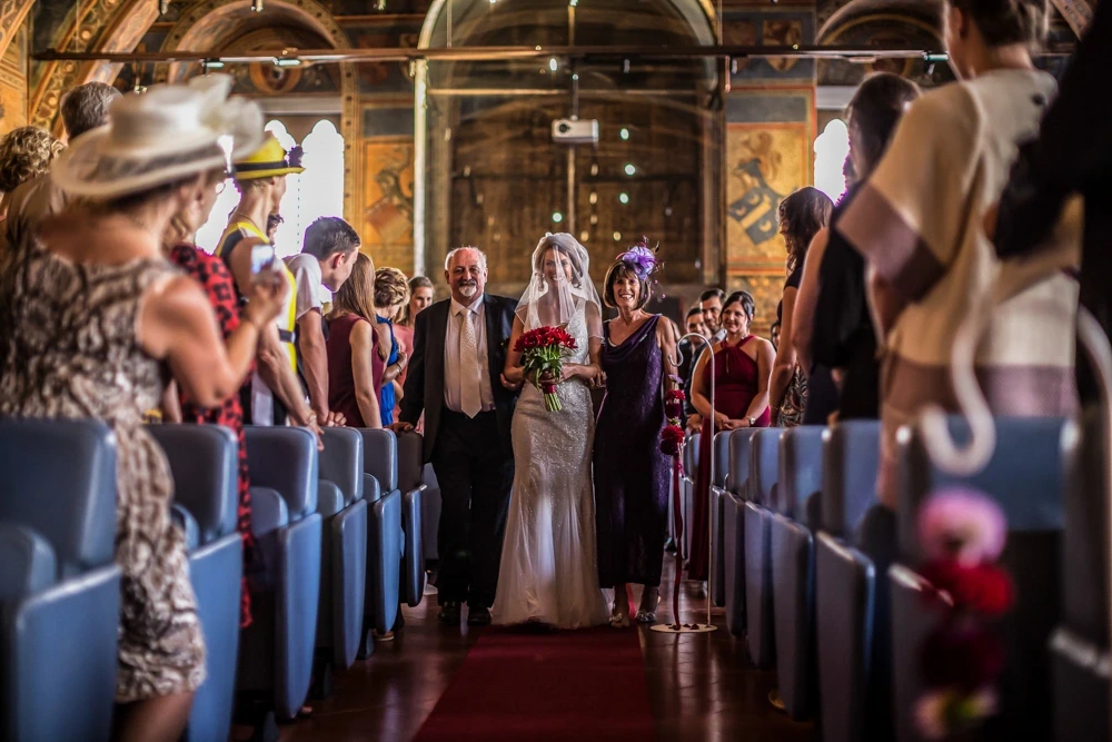 The entrance into the church, escorted down the aisle between the guests.