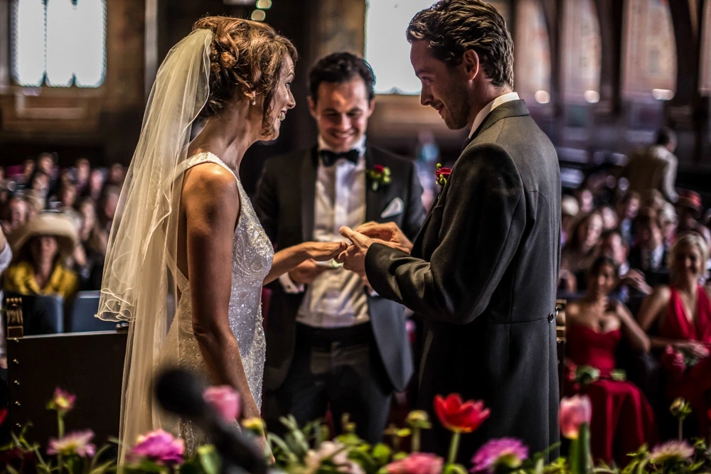 The exchange of rings, before the crowd of guests.