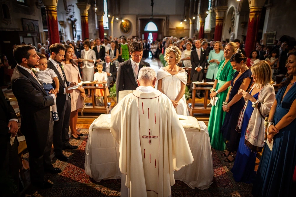 In the church, the celebrant at the altar seen from behind.