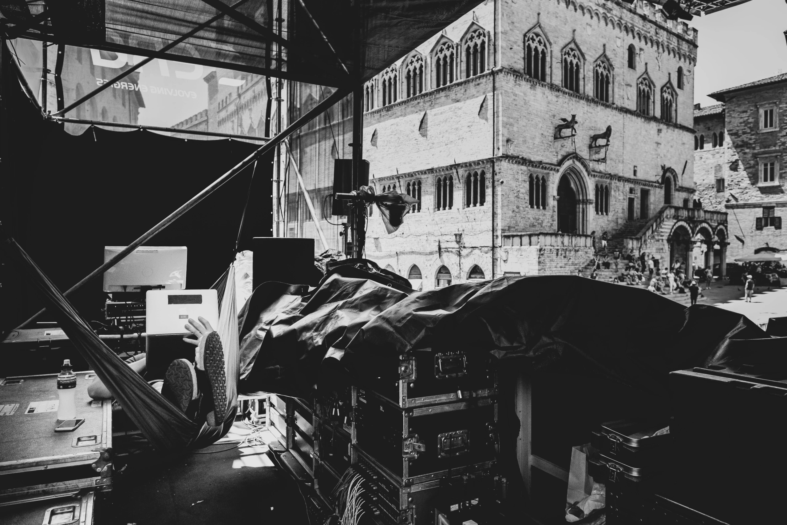 Behind the stage, the equipment cases and the palazzo beyond.