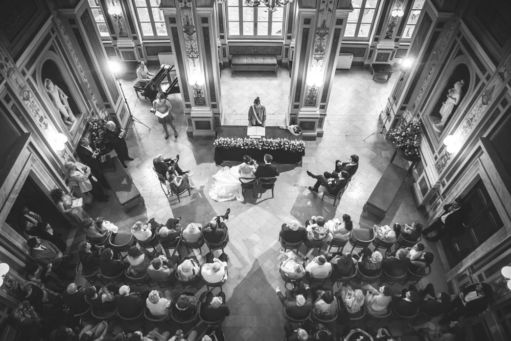 From above, the ceremony in the frescoed hall among the seated guests.