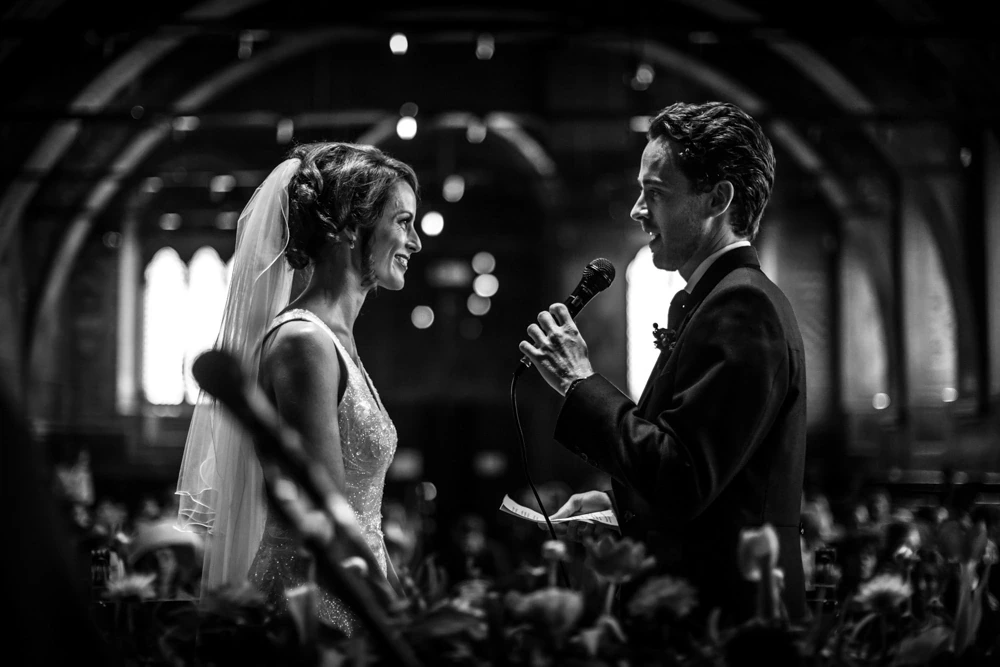 Facing each other, microphone in hand before the guests.
