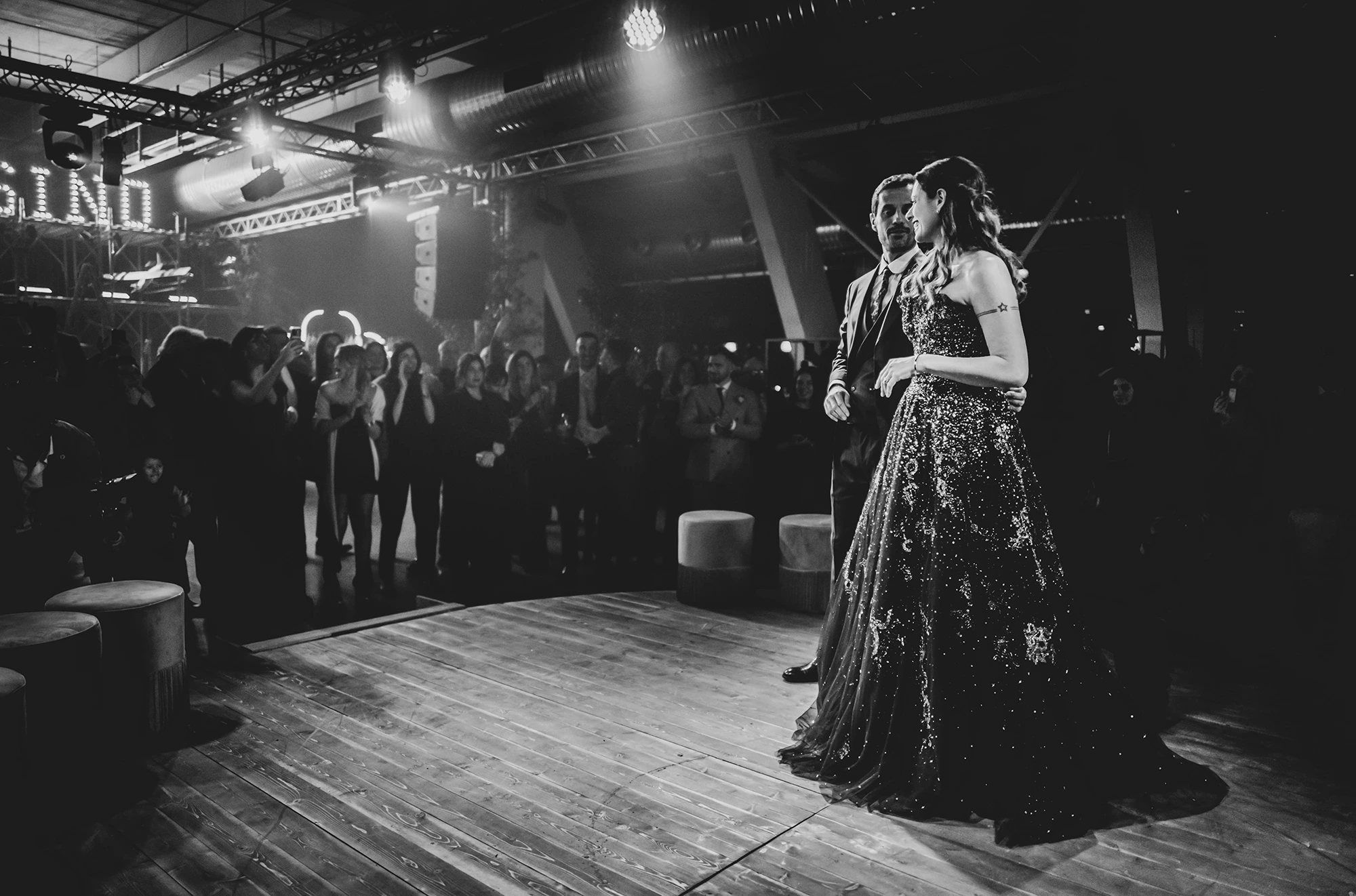 On the dance floor of the industrial hall, the couple alone before the guests.