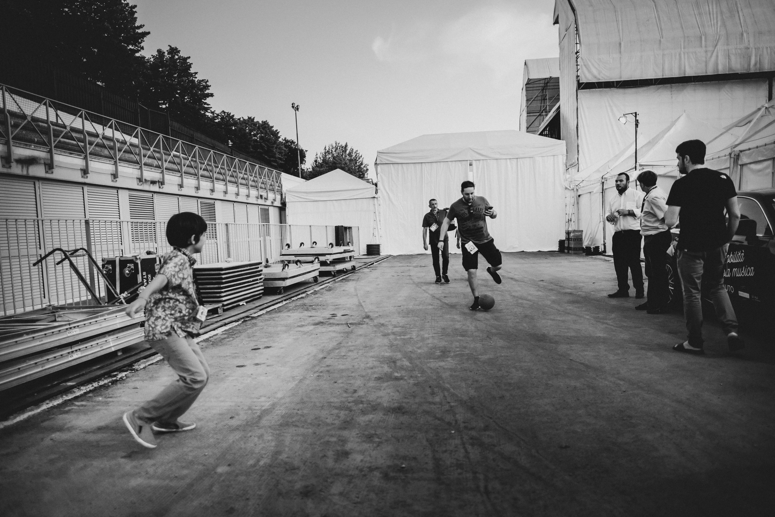 In the service area between the marquees, a game of football.