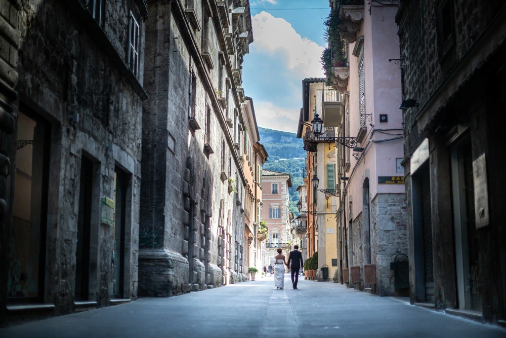 At the end of the empty street, the couple small in the distance.