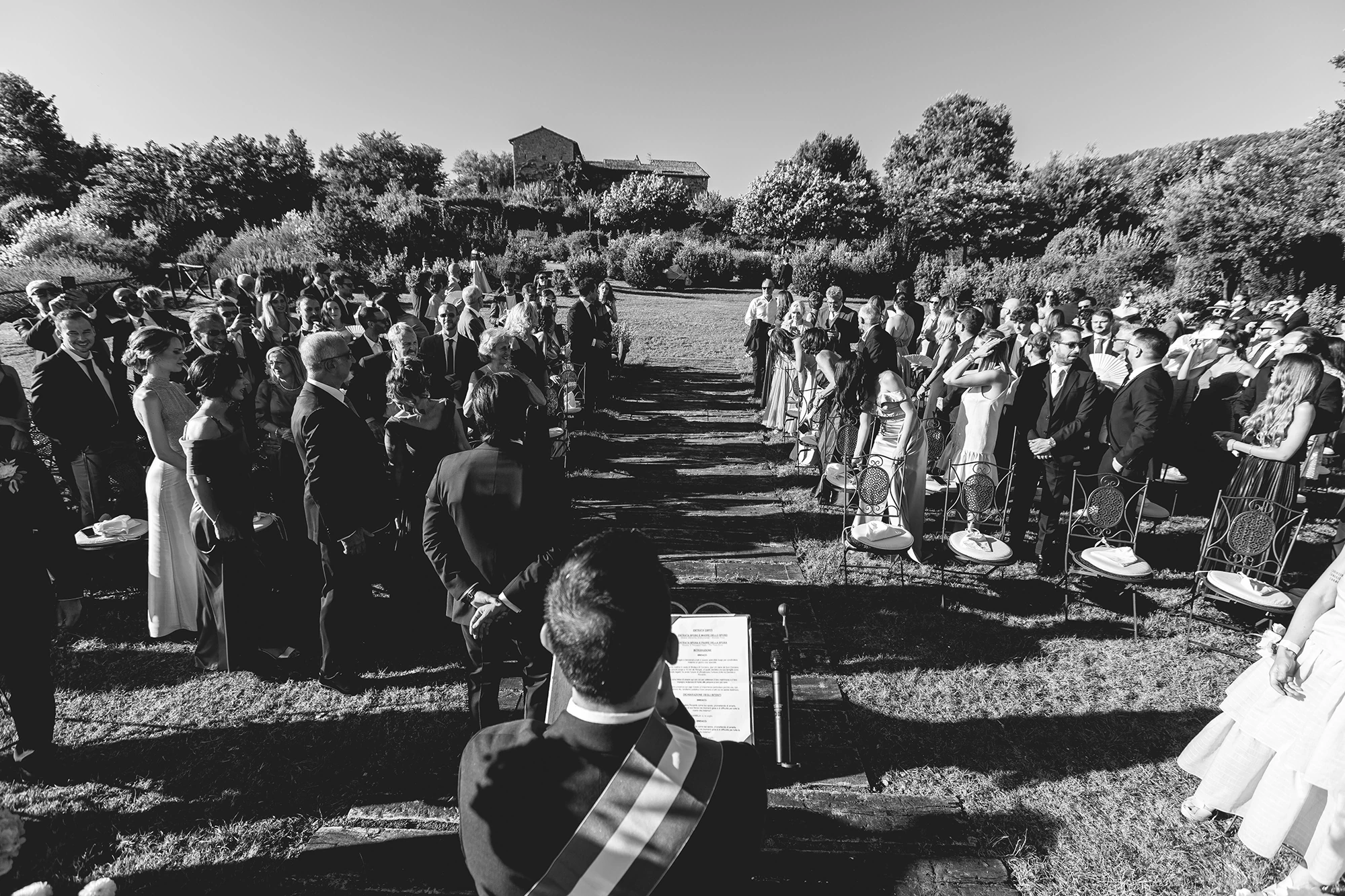 From the back, the guests standing on the lawn during the ceremony.