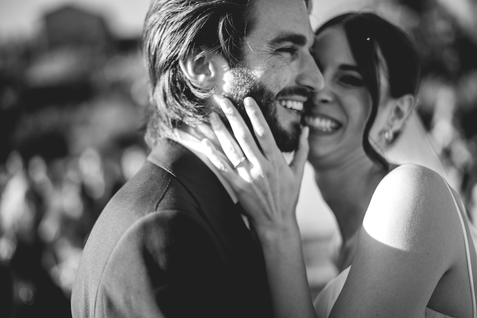 In the embrace, a hand on his face and laughter close by.