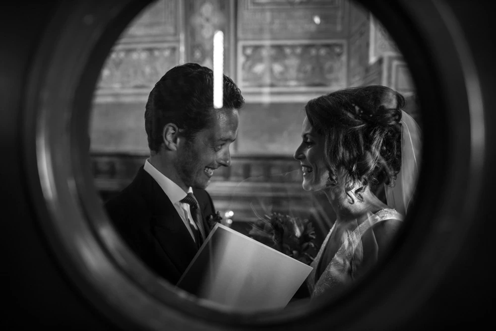 Through a round mirror, the couple facing each other.