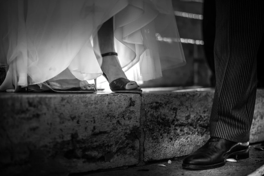 Feet on the steps: the bride's shoe beside the groom's.
