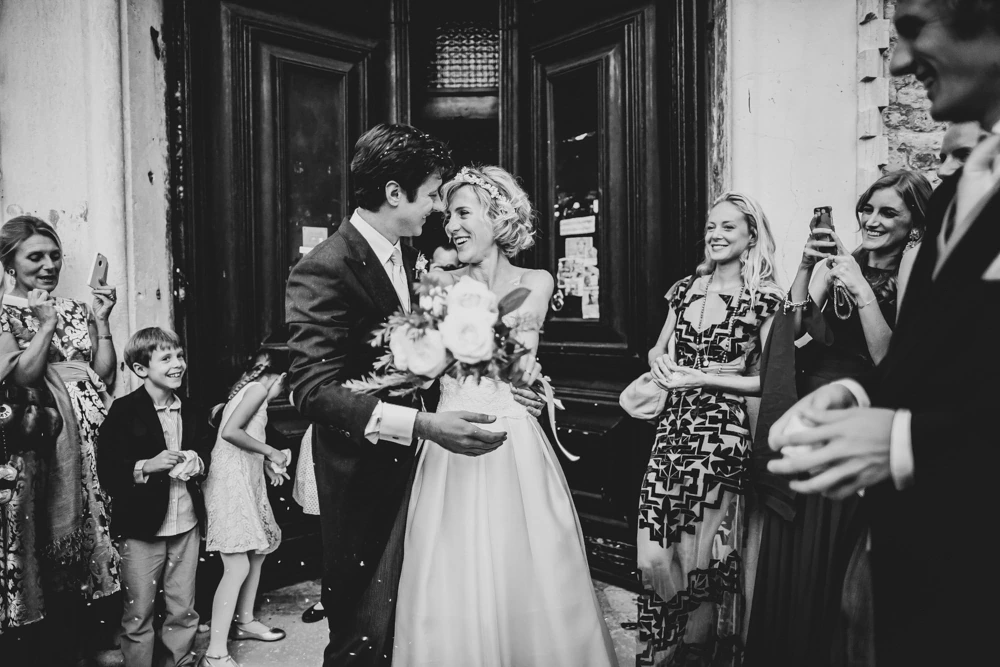 In the doorway, the couple among the guests and a little girl.