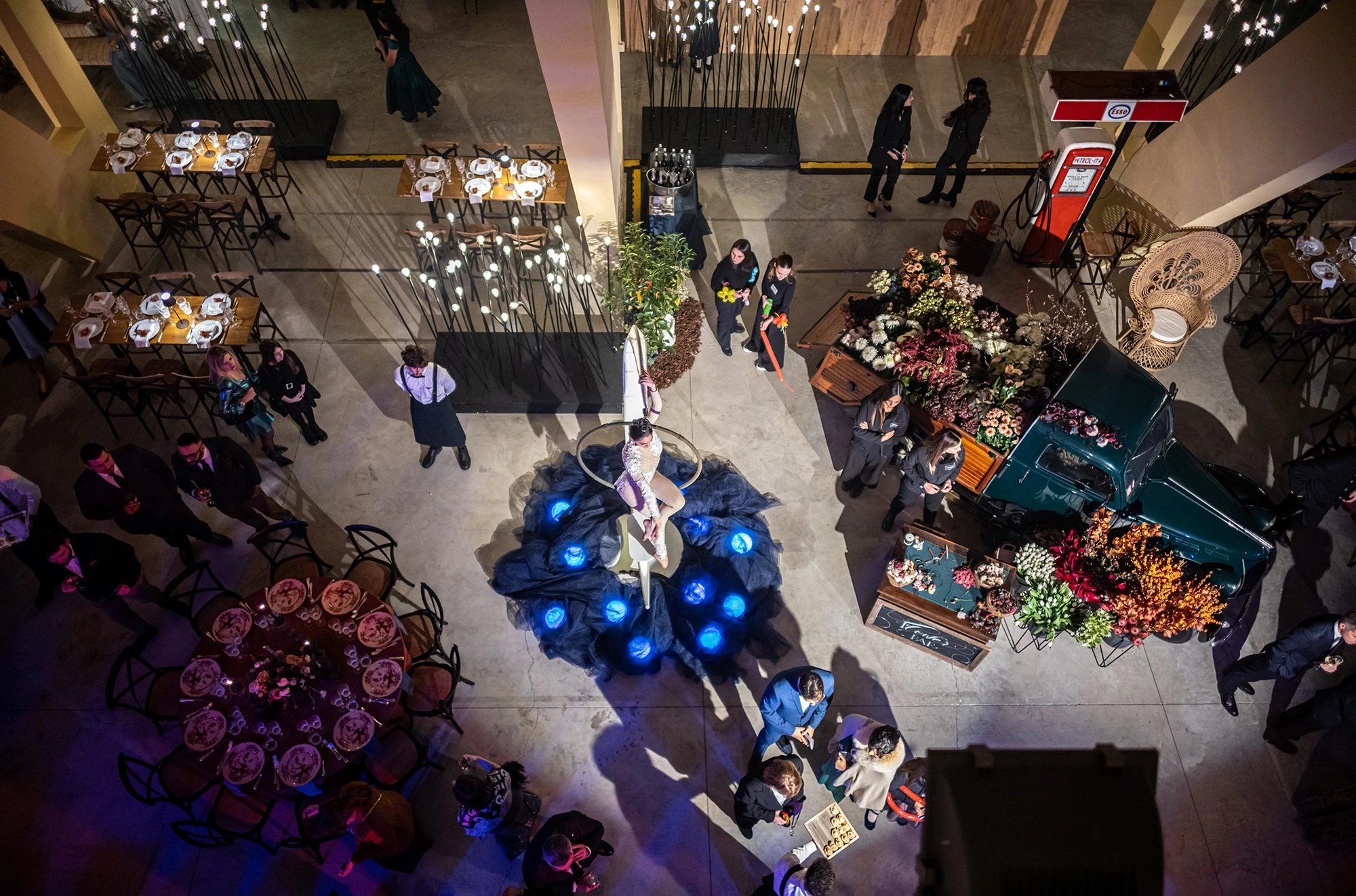 From above, the room laid out with round tables and flowers.