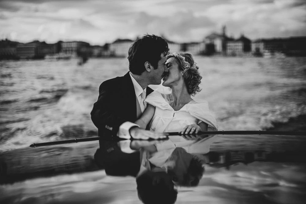 On the boat, a kiss with the city behind.