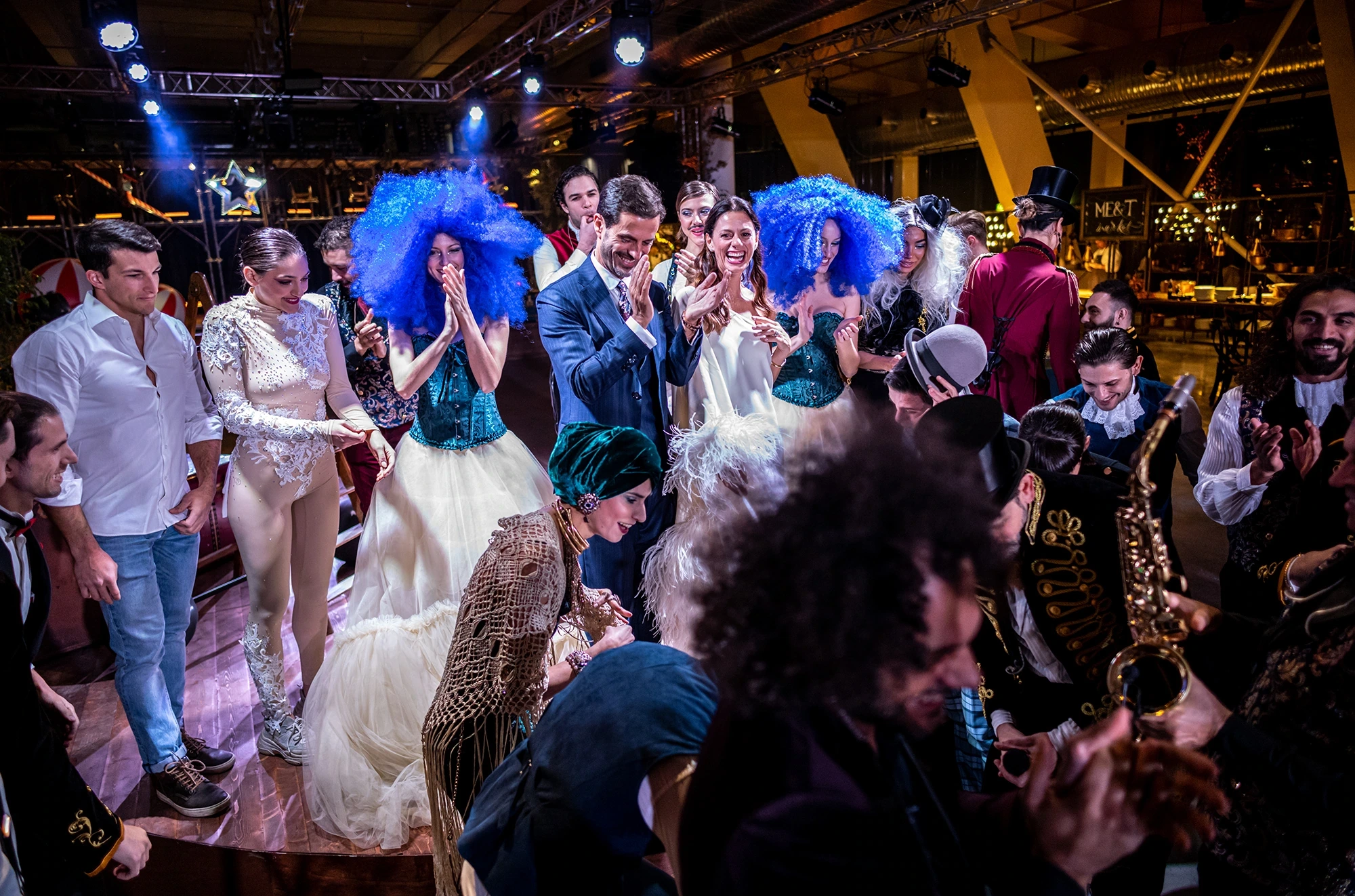 On the dance floor, guests dancing in blue wigs.