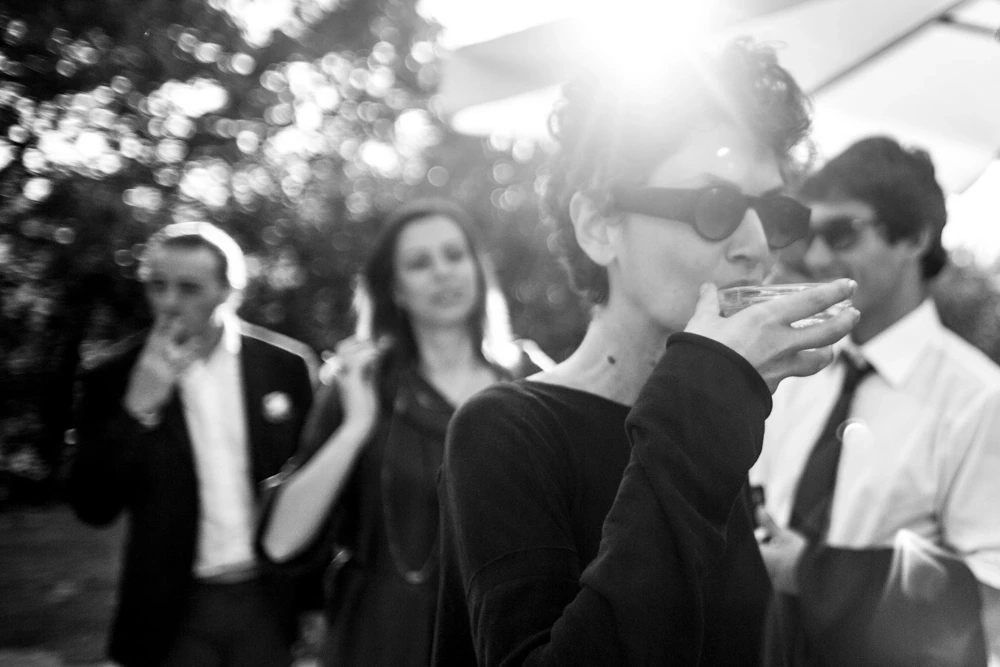 Among the guests, a sip from the glass in the backlight.