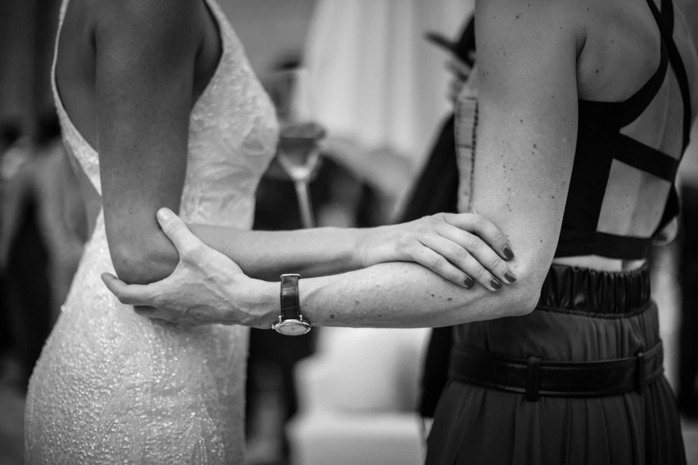 A hand on the bride's arm.