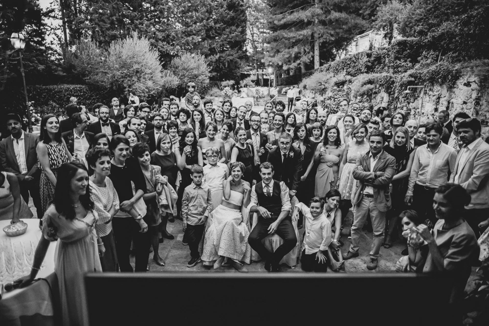 The group photograph with all the guests, outdoors.