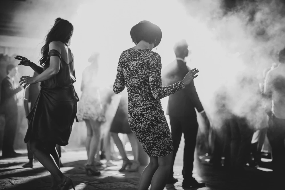 Dancing before a cloud of white smoke.