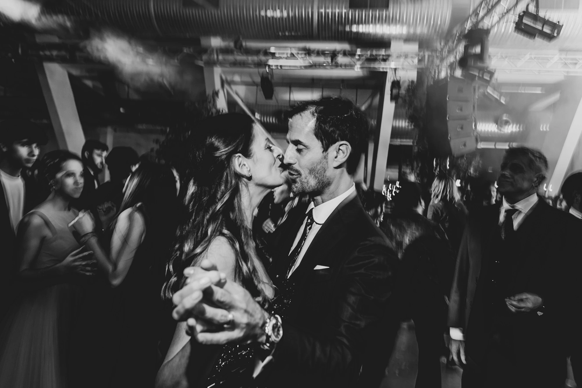 On the dance floor, a kiss among the crowd.